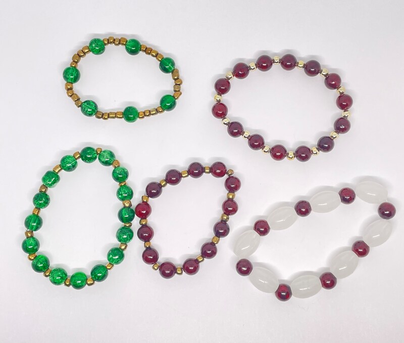 Red beaded bracelets and green beaded bracelets with gold spacers